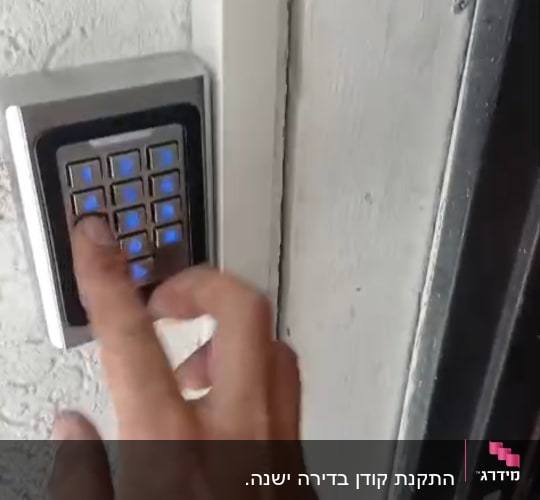יד לוחצת על מקלדת כניסה לדלת